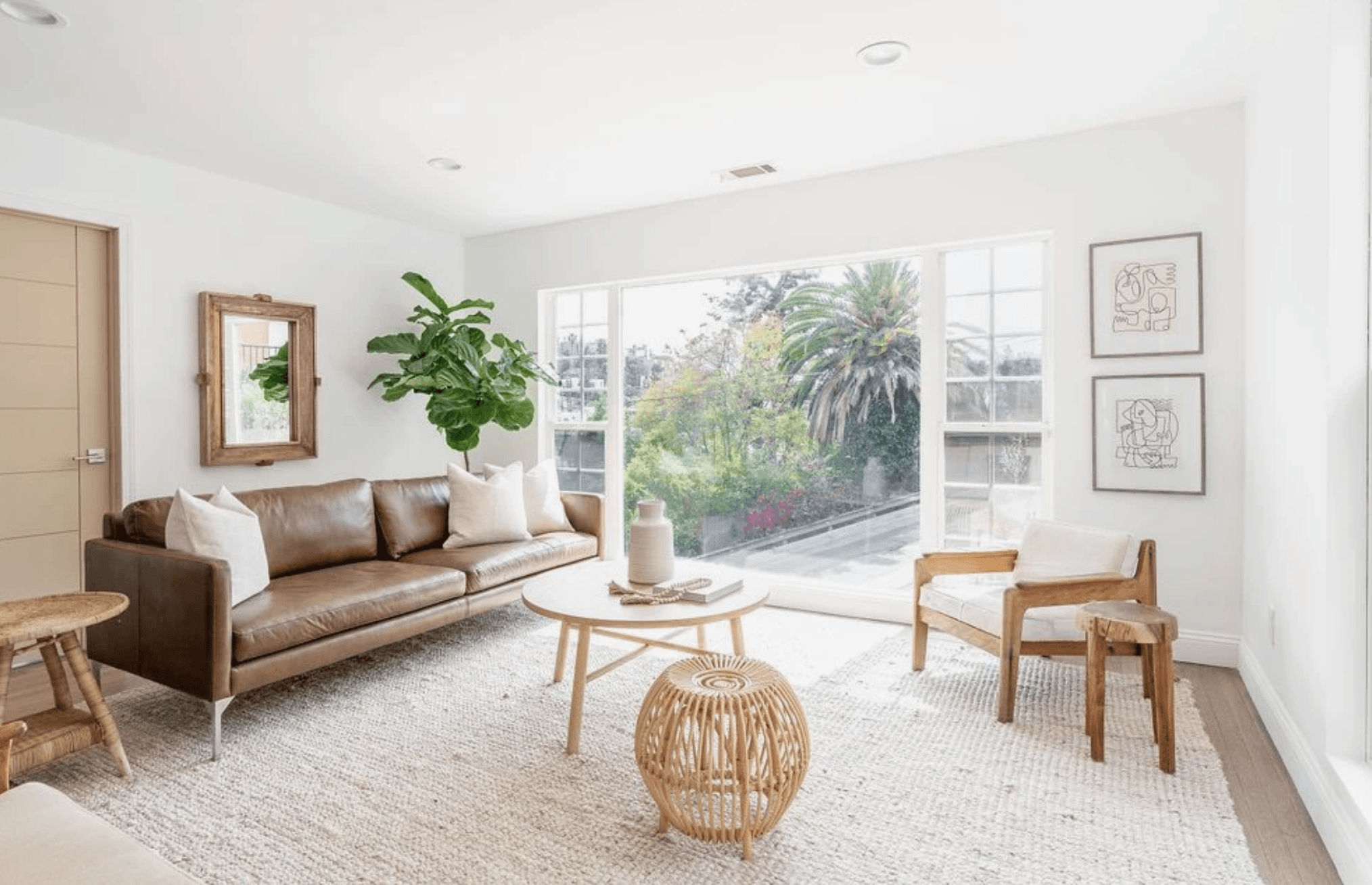 A customer's living room with a brown leather sofa, photographed on their phone